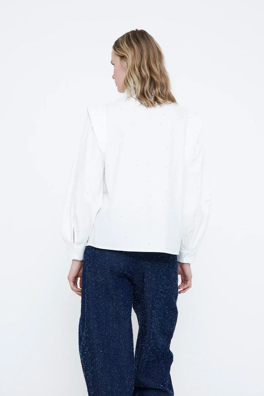 Camicia bianca con dettaglio di applicazioni