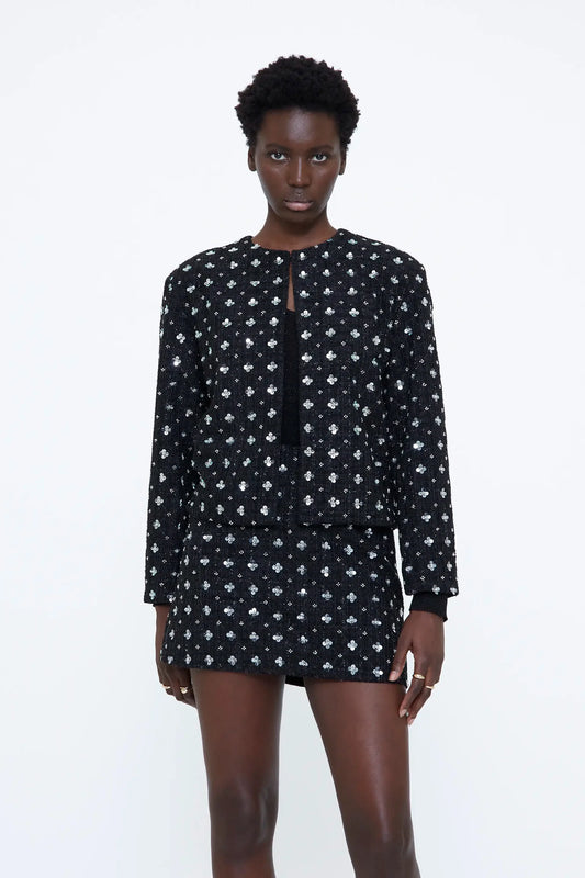 Giacca in tweed nera con dettagli floreali